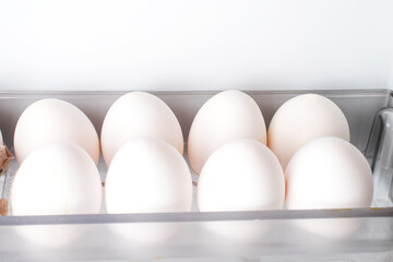 Chicken Eggs on tray of a refrigerator. Food concept.