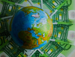 Globe world map lie on  euro  banknote money background . Finance, Account, Statistics, Investment, Analytic research data economy and Business company meeting concept.