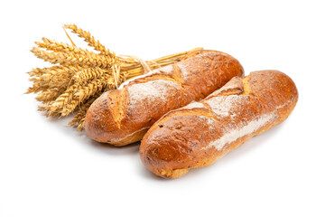 two breads and a bunch of wheat spikelets on a white background