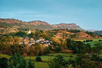 Panoramic view of a small village surrounded by fields in the trekking from Kalaw to Inle lake in Myanmar