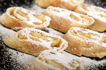 Apple roll with powdered sugar. Close up