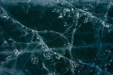 white cracks in transparent ice on the lake