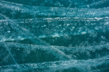 white cracks in transparent ice on the lake