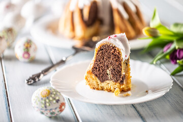 A cut piece of Easter marble cake on a white plate