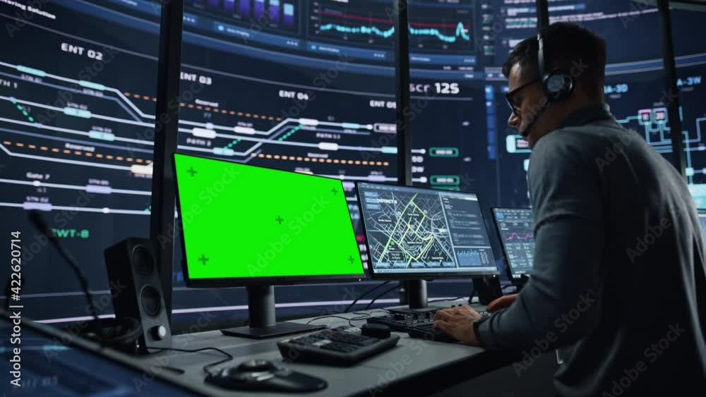 Aufkleber Professional IT Technical Support Specialist and Software Developer Working on Computer with Green Screen Mock Up Display in Monitoring Control Room with Digital Screens. Employee Wears Headphones.