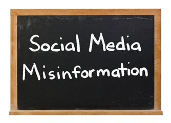 Obraz premium Social Media Misinformation written in white chalk on a black chalkboard isolated on white