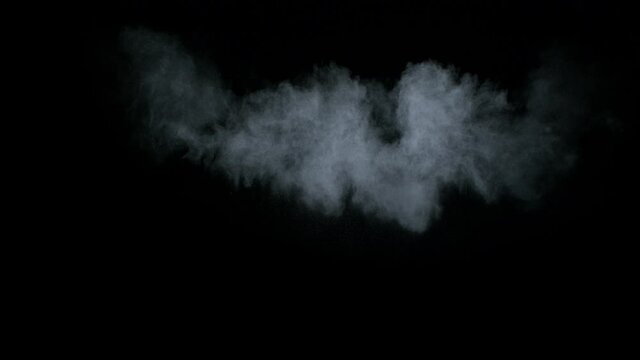Misty chalk clouds blowing into the center. Isolated super slow motion white smoke and fog wisp on black background. Studio concept and VFX plate shot for scene overlay and creative enhancement.