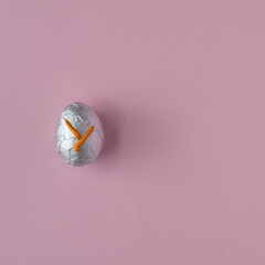 Easter egg on a pastel pink background with creative copy space. Minimal Easter holiday concept