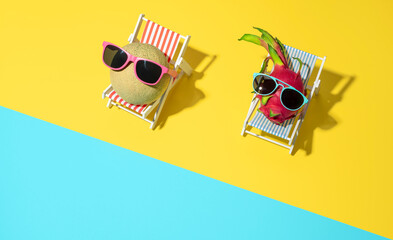 Summer holiday concept with exotic fruits on sunbeds on the beach.