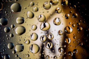 Raindrops on glass with great coffee color background