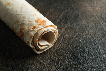 Pita bread close-up on a dark background with copy space.