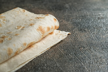 Pita bread close-up on a dark background with copy space.