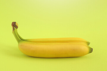 Fresh organic bananas with a green background. Beautiful exotic fruit. Healthy fruit concept. Food background