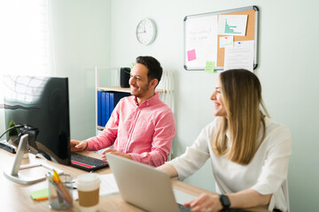 Happy colleagues having fun while working at the office