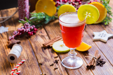 the hot apple punch in a glass on a wooden table