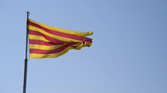 Catalonia Flag against the blue sky in Barcelona, Spain