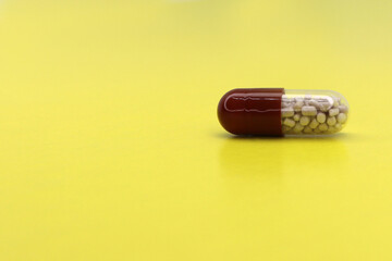 Tablet on a yellow background, a medical concept for background and text