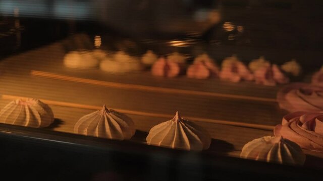 cooking sweet dessert meringue in the oven close-up