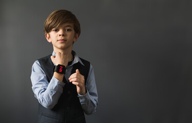 Portrait image of a little boy with a wrist watch