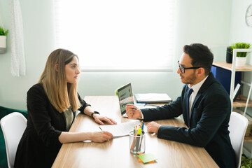 Professional lawyer signing a business deal with a female client