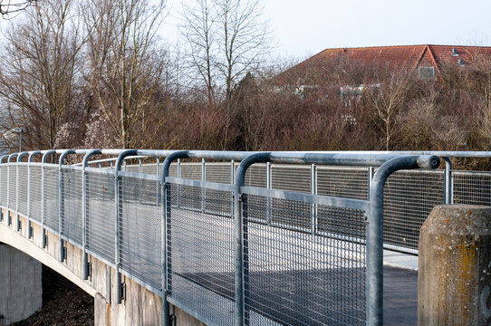 view alongside the metal railing of a bridge