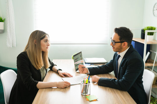 Professional lawyer signing a business deal with a female client