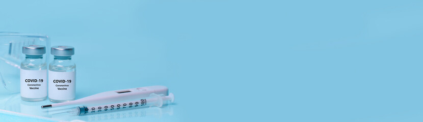 Medical bottles, vials,vaccine, syringe , face mask,body thermometer  protective glasses. The concept of medicine, healthcare , science.Coronavirus vaccine, immunity improvement.Copy space for text.