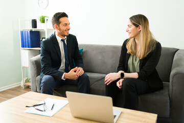 Attractive coworkers talking during a business meeting