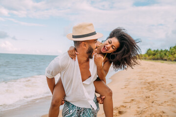 Young Couple On Beach Summer Vacation, Happy Smiling Man Carry Woman Back Seaside
