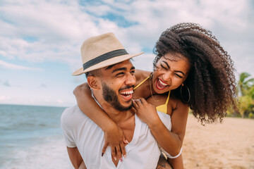 Young Couple On Beach Summer Vacation, Happy Smiling Man Carry Woman Back Seaside