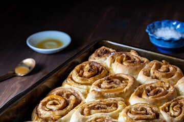 Close up of a baking pan filled with homemade salted caramel cinnamon buns.
