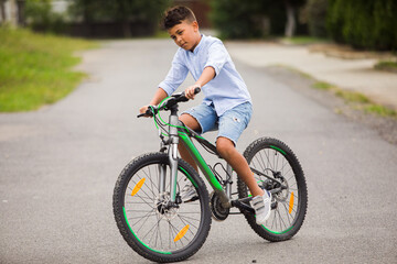 Teenage boy is riding on a bicycle