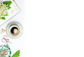 Home office desk with coffee cup, bouquet of spring flowers flat lay. Workplace with notebook and...