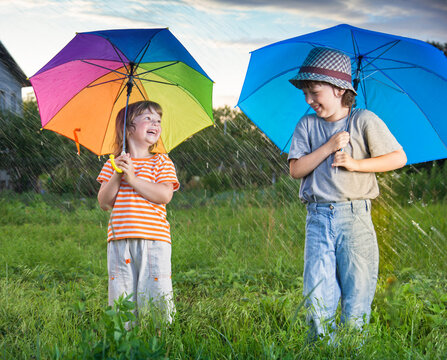 two happy brother with umbrella summer outdoors