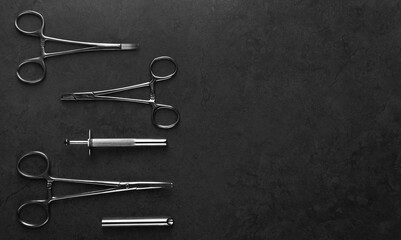 A group of surgical stainless steel body piercing clamps and equipment