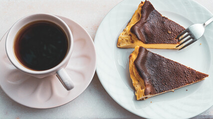 Cheesecake slice on white plate with coffee or tea on white background. Cinematic photo of nutrition.