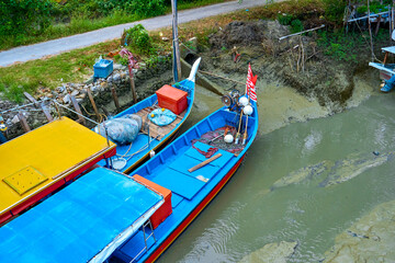Fishing village in Asia. The boats are on land near the river