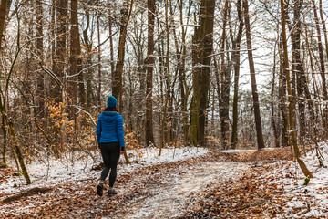 Woman on winter walk in the park or forest