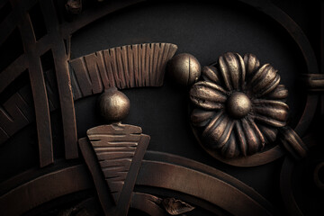 Old gate with decorative wrought red elements