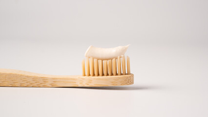 Wooden eco toothbrush with toothpaste on a white background. Bamboo toothbrush.