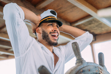 Sailing sport. Captain in charge. Latin american man wearing ship captain's hat worried about pirates