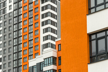 Fototapeta premium The facade of a multi-storey building with windows and balconies as an element of the architecture of a modern city