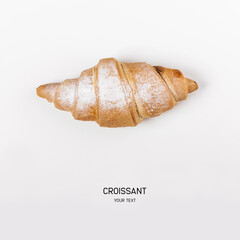 fresh croissant with powder on white background. space for text