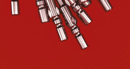 Replaceable bits close-up view, a pile of metal screwdriver bits, banner photo