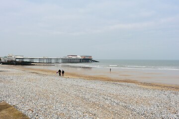 Cromer, Nortfolk, pier on a foggy morning, winter, seaside gentle waves crashing on the shore,...
