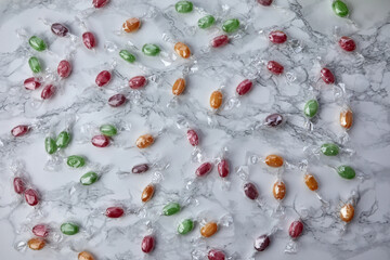 colorful candies on a marble kitchen table - 422643396