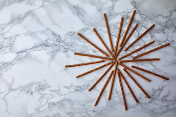 fresh pretzel sticks on a marble table - 422643706