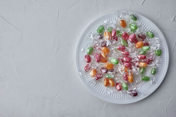 colorful candies in plate on a kitchen table - 422643906