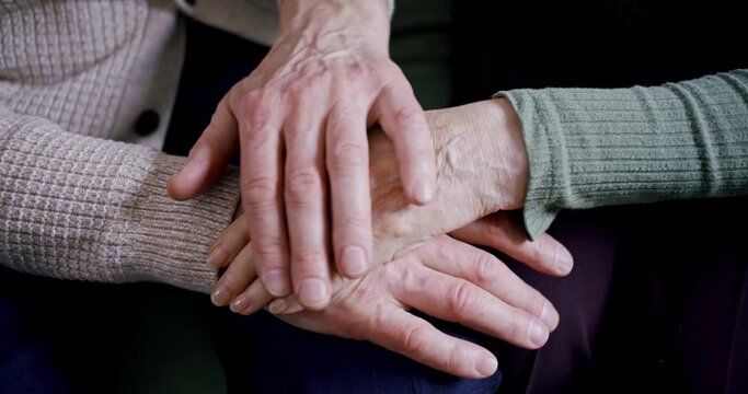 close-up of old people's hands. the male hand of an elderly man strokes the woman's hand of an elderly woman soothing pats. an image of long marriage and mutual understanding.