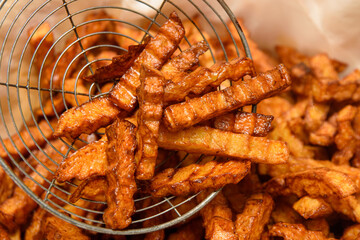 French fries are fried in a deep fat fryer.